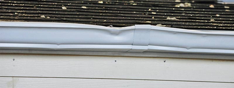 Hail-damaged roof shingles with dents inspected by Committed 365 Roofing & Exteriors
