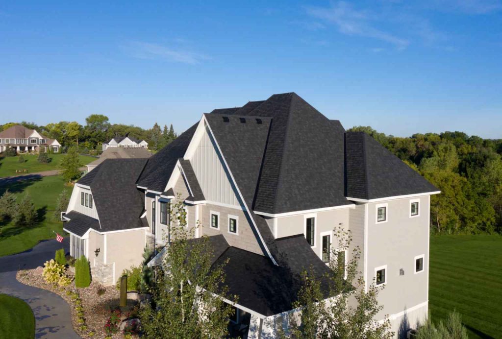 Aerial view of a home featuring asphalt shingle roofing installed by Committed Roofing & Exteriors.
