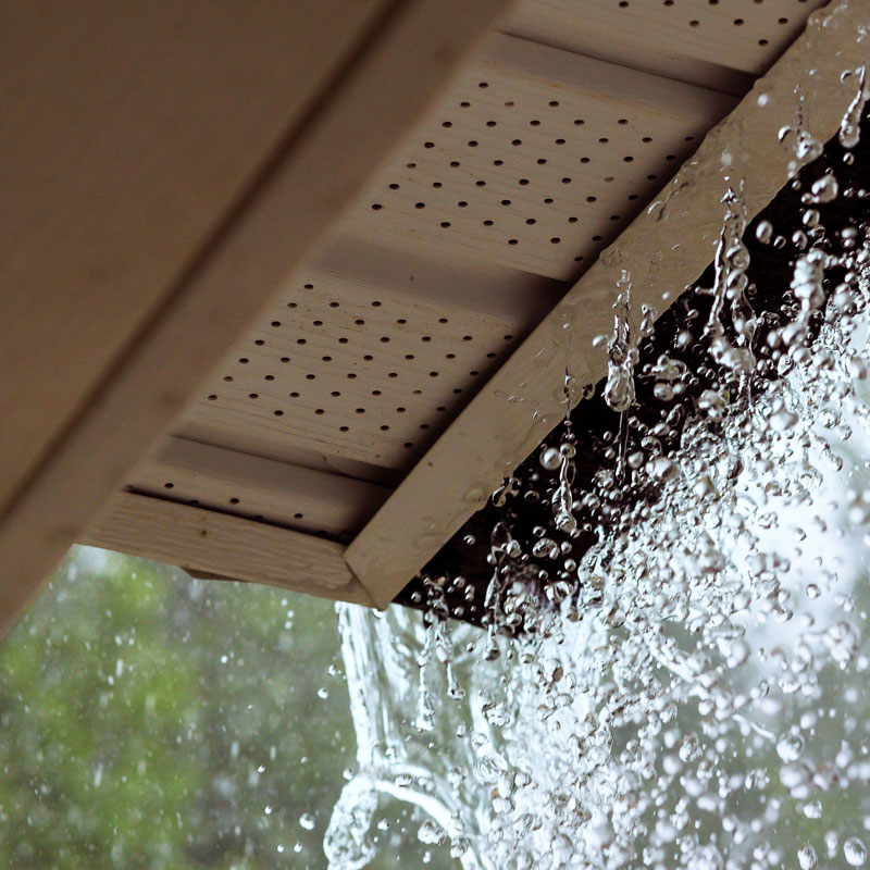 during a downpour water escapes from the over gutter
