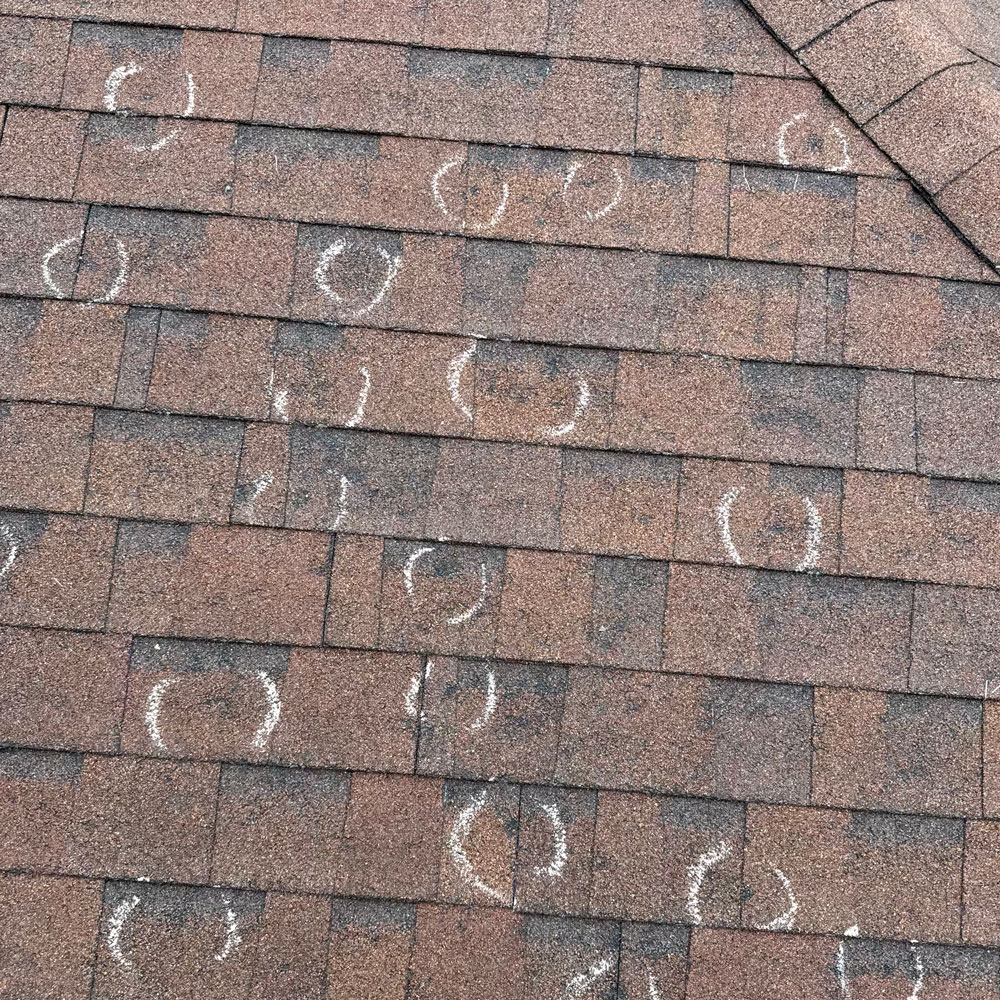 hail damage spots on asphalt shingle roof home storm