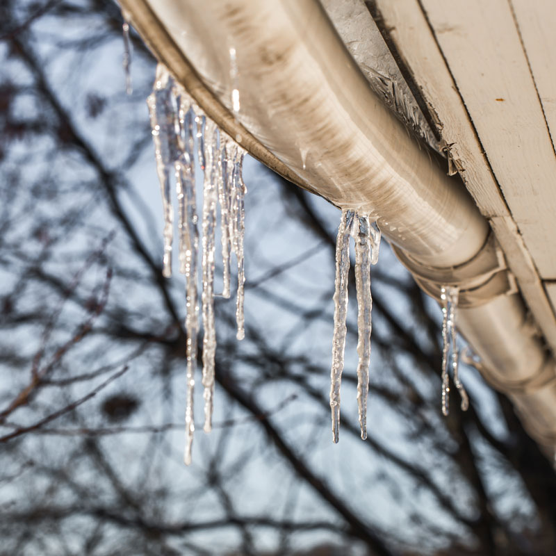 ice icicles on the roofs of houses